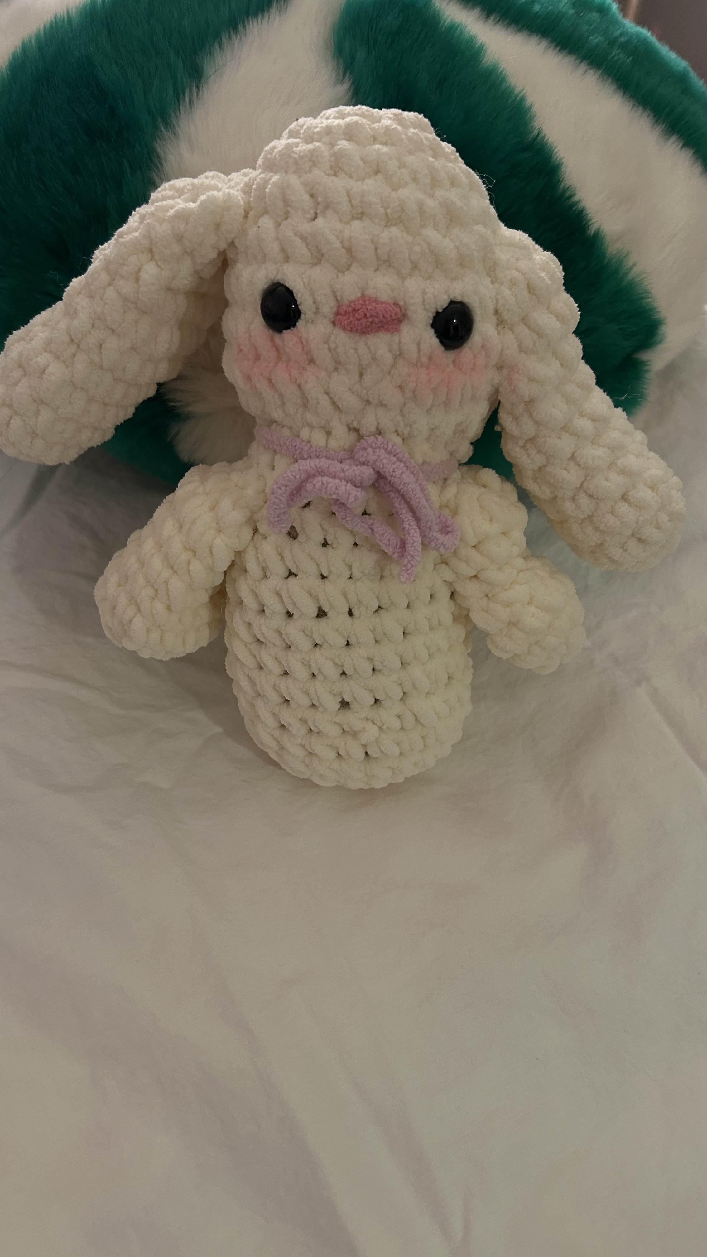 Crocheted cream bunny with a pink bow tie