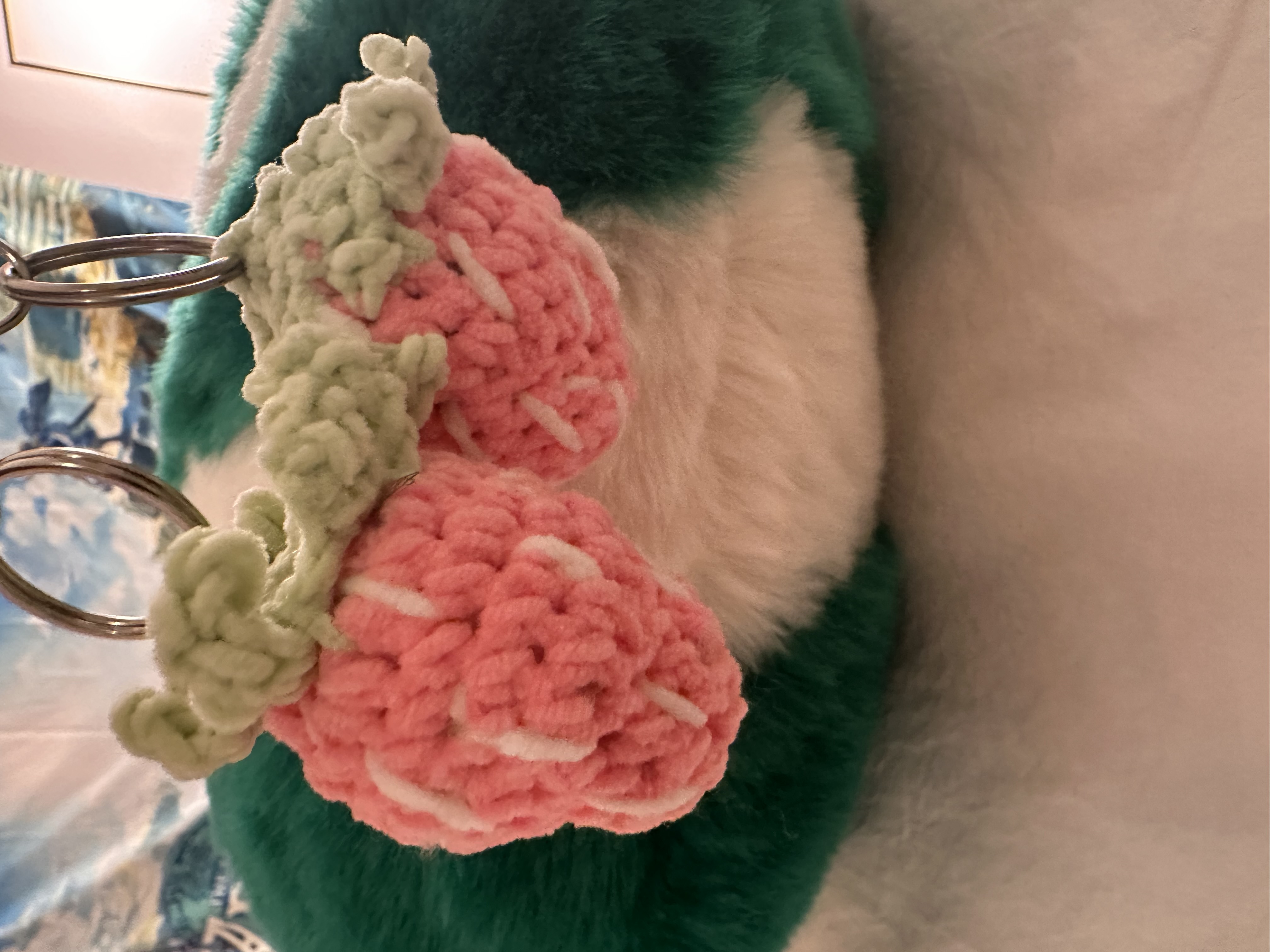 Two crocheted strawberry keyrings